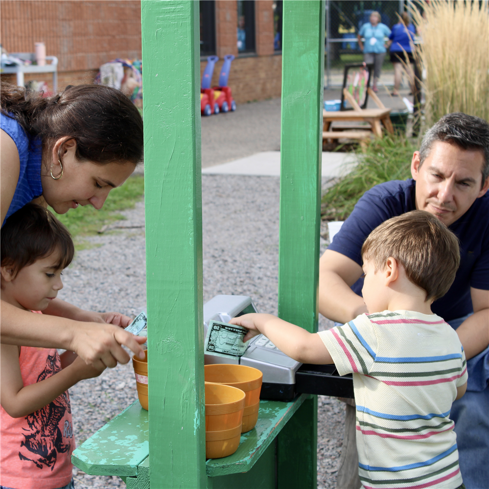  Family playing at veggie stand
